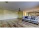 Open living room with hardwood floors and a view of the kitchen at 11309 Outrigger Ave, Spring Hill, FL 34608