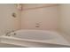 Clean bathroom with a built-in tub and tiled walls at 17980 Gulf Blvd # 103, Redington Shores, FL 33708