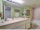 Bright bathroom with double sinks and granite countertop at 17980 Gulf Blvd # 103, Redington Shores, FL 33708
