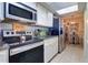 Modern kitchen with stainless steel appliances and breakfast bar at 17980 Gulf Blvd # 103, Redington Shores, FL 33708