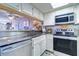 Kitchen features stainless steel appliances and white cabinets at 17980 Gulf Blvd # 103, Redington Shores, FL 33708