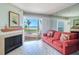 Cozy living room with water views and a decorative fireplace, creating a relaxing atmosphere at 17980 Gulf Blvd # 103, Redington Shores, FL 33708