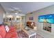 Bright living room with coastal decor and TV at 17980 Gulf Blvd # 103, Redington Shores, FL 33708