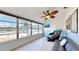 Sunroom boasts a relaxing view, ceiling fan, and comfortable seating at 1898 Shore Dr S # 317, South Pasadena, FL 33707