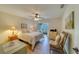 Bedroom with king bed, access to balcony, and wood floors at 2035 Nash Dr, Clearwater, FL 33763