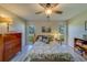 Bedroom with a queen-size bed, dresser, and large windows at 2035 Nash Dr, Clearwater, FL 33763
