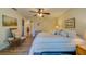 Bright bedroom with a king-size bed and wood-look floors at 2035 Nash Dr, Clearwater, FL 33763
