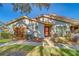 Front view of a charming villa with a red door and walkway at 2035 Nash Dr, Clearwater, FL 33763