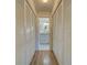 Long hallway with built-in storage and light wood floors at 2035 Nash Dr, Clearwater, FL 33763