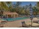 Inviting community pool with lounge chairs and umbrella at 2035 Nash Dr, Clearwater, FL 33763