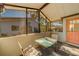 Covered patio with seating, screened enclosure, and door access at 2035 Nash Dr, Clearwater, FL 33763