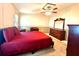 Comfortable bedroom featuring neutral walls, a ceiling fan, and a full set of wood furniture at 225 N Saint Thomas Cir, Apollo Beach, FL 33572