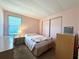 Bedroom with double bed, matching nightstand and dresser, light pink walls, and sliding-door closet at 225 N Saint Thomas Cir, Apollo Beach, FL 33572