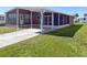 Charming home featuring a covered carport and screened in porch, perfect for enjoying the outdoors at 225 N Saint Thomas Cir, Apollo Beach, FL 33572