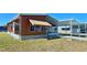 Cozy home with a covered carport and awning to provide shade at 225 N Saint Thomas Cir, Apollo Beach, FL 33572