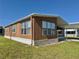 Charming home featuring large windows, exterior rock details, a side patio and covered parking at 225 N Saint Thomas Cir, Apollo Beach, FL 33572