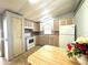 View of kitchen with white appliances, ample cabinet space and a breakfast table at 225 N Saint Thomas Cir, Apollo Beach, FL 33572