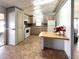 Functional kitchen featuring tile flooring, breakfast bar, matching cabinets, and modern appliances at 225 N Saint Thomas Cir, Apollo Beach, FL 33572