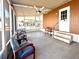Screened-in patio with ceiling fan, plenty of seating, and nice view of the community at 225 N Saint Thomas Cir, Apollo Beach, FL 33572