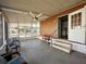 Screened-in patio with ceiling fan, plenty of seating, and nice view of the community at 225 N Saint Thomas Cir, Apollo Beach, FL 33572