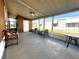 Screened-in patio with ceiling fan, plenty of seating, and nice view of the community at 225 N Saint Thomas Cir, Apollo Beach, FL 33572