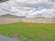 Large grassy backyard with a vinyl fence at 22547 Storybook Cabin Way, Land O Lakes, FL 34637