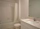 Clean bathroom boasts a bathtub, toilet and modern vanity at 22547 Storybook Cabin Way, Land O Lakes, FL 34637