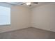 Simple carpeted bedroom with neutral walls and a window offering natural light at 22547 Storybook Cabin Way, Land O Lakes, FL 34637