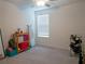 Well-lit bedroom with carpeted floor and window blinds at 22547 Storybook Cabin Way, Land O Lakes, FL 34637
