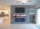 Living room with a modern fireplace and built-in shelving at 22547 Storybook Cabin Way, Land O Lakes, FL 34637