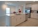 Large kitchen island with white cabinets and quartz countertops at 22547 Storybook Cabin Way, Land O Lakes, FL 34637