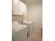 Laundry room with washer, dryer, and upper cabinets at 22547 Storybook Cabin Way, Land O Lakes, FL 34637
