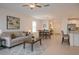 Comfortable living room featuring a ceiling fan, a neutral color scheme, and plenty of natural light at 22547 Storybook Cabin Way, Land O Lakes, FL 34637
