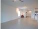 Open living area with tile floors and a view into the kitchen at 22547 Storybook Cabin Way, Land O Lakes, FL 34637