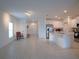 Open living room and kitchen with tile flooring, and a view of the kitchen at 22547 Storybook Cabin Way, Land O Lakes, FL 34637