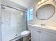 A well-lit bathroom with a glass shower enclosure and a modern vanity creates a clean space at 22702 Penny Loop, Land O Lakes, FL 34639
