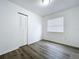 Minimalist bedroom with vinyl flooring, a window and closet at 22702 Penny Loop, Land O Lakes, FL 34639