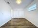 Bright bedroom with wood-look flooring and double door closet at 22702 Penny Loop, Land O Lakes, FL 34639