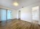 Bedroom with wood-look floors and access to a bathroom at 22702 Penny Loop, Land O Lakes, FL 34639