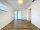 Well-lit bedroom featuring wood-look floors and access to a bathroom at 22702 Penny Loop, Land O Lakes, FL 34639