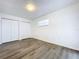 Spacious bedroom with wood-look flooring and double door closet at 22702 Penny Loop, Land O Lakes, FL 34639