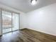Bedroom with wood-look floors and sliding glass doors at 22702 Penny Loop, Land O Lakes, FL 34639