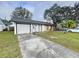 Charming single-story home with attached garage and front lawn at 22702 Penny Loop, Land O Lakes, FL 34639