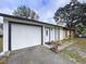 Two-toned house with attached garage and landscaping at 22702 Penny Loop, Land O Lakes, FL 34639