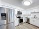 Updated kitchen boasts stainless steel appliances and white cabinetry at 22702 Penny Loop, Land O Lakes, FL 34639