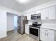 Bright kitchen, featuring stainless steel appliances and white cabinets at 22702 Penny Loop, Land O Lakes, FL 34639