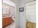 Bathroom with granite countertop, wood cabinets and walk-in closet at 3309 Lori Ln, New Port Richey, FL 34655
