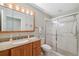 Updated bathroom with granite vanity, shower, and tile flooring at 3309 Lori Ln, New Port Richey, FL 34655