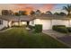 Exterior view of a charming villa with a two-car garage and well-manicured lawn at 3309 Lori Ln, New Port Richey, FL 34655