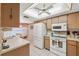 Kitchen features white appliances and light-brown cabinets at 3309 Lori Ln, New Port Richey, FL 34655